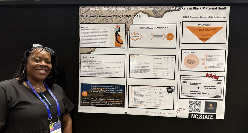 person standing in front of their poster presentation at recent NASW conference